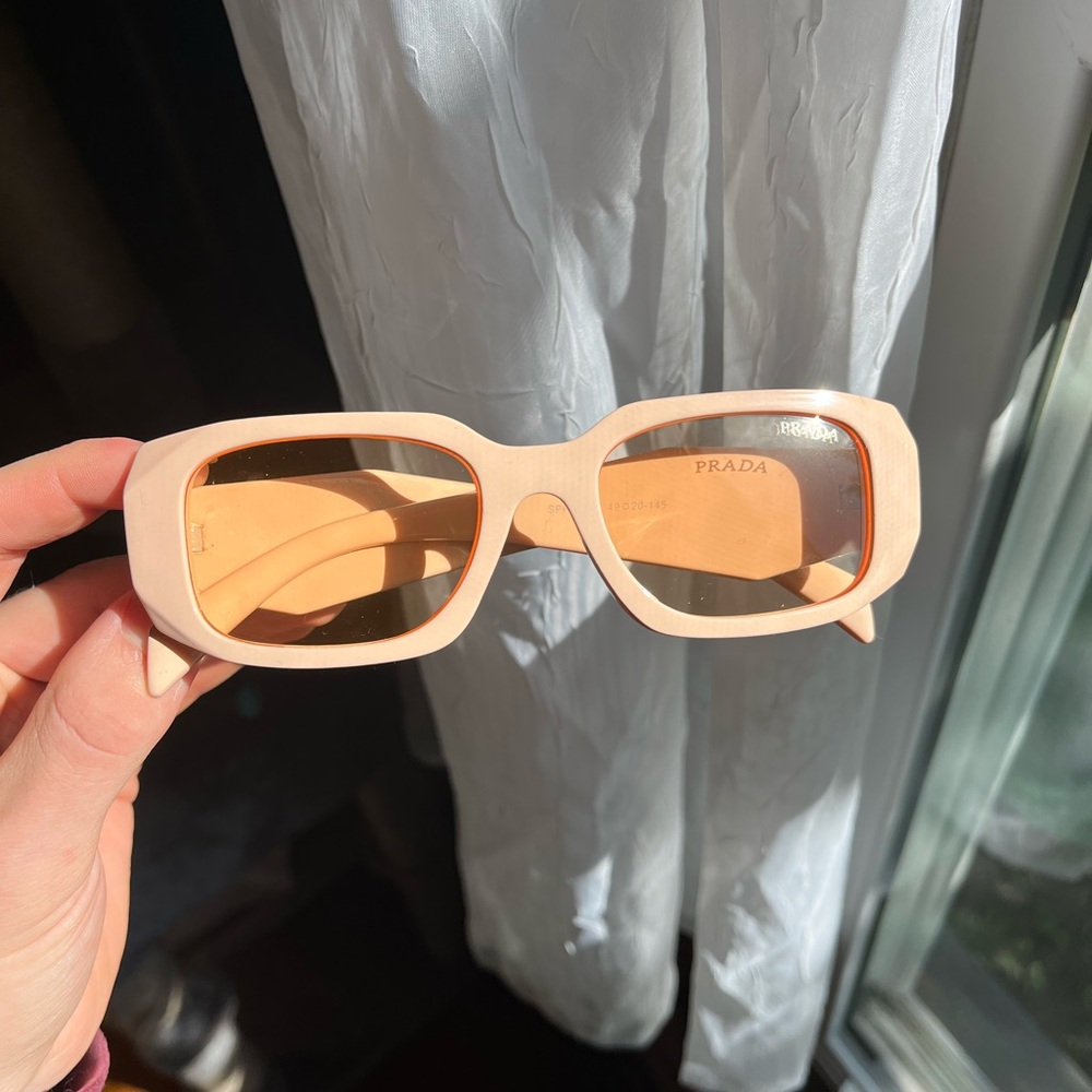 Cream color symbole frame with gold accents elegant look prada